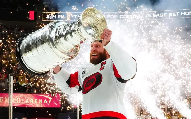 Jordan Staal, capitão do Carolina Hurricanes, levanta a Stanley Cup após a vitória sobre o Vegas Golden Knights no Jogo 6 da final da Stanley Cup 2026 – CAR@VGK, SCF, Gm 6: Hurricanes celebrate as Stanley Cup champions – Fonte: NHL (2026).